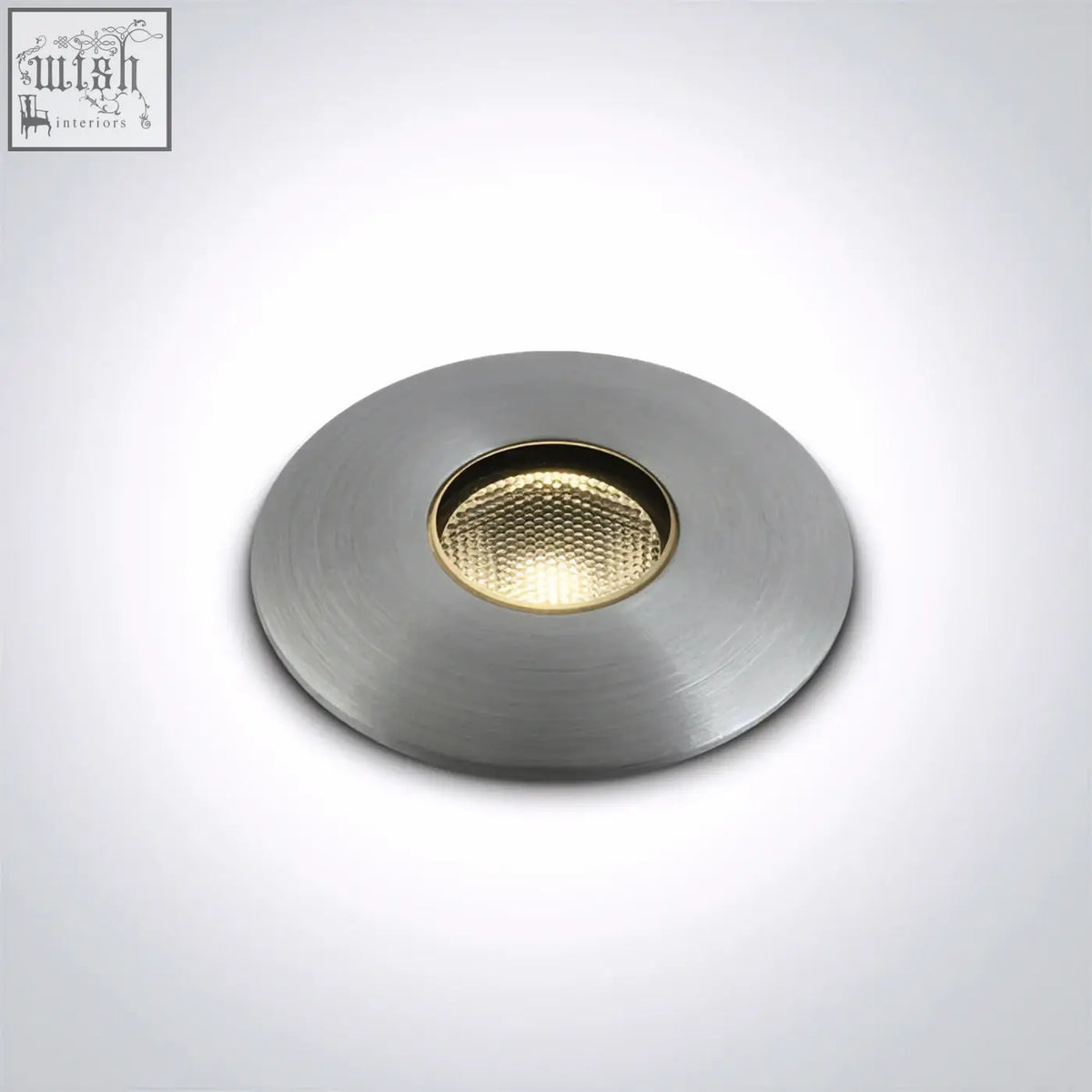 Circular recessed led inground light with brushed metallic finish and gold toned textured lens for path illumination