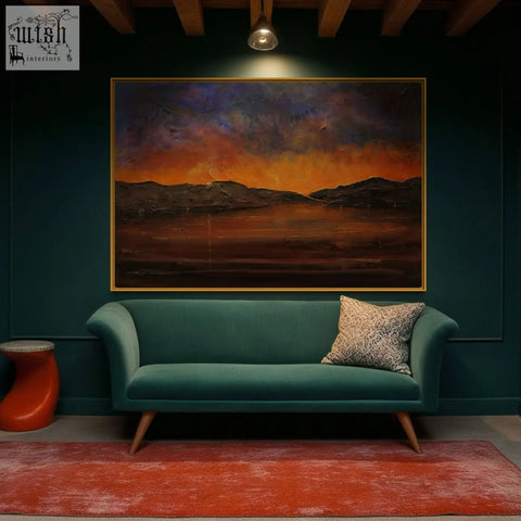 Teal velvet sofa with wooden legs and patterned throw pillow next to brooding clyde dusk art print from scotland