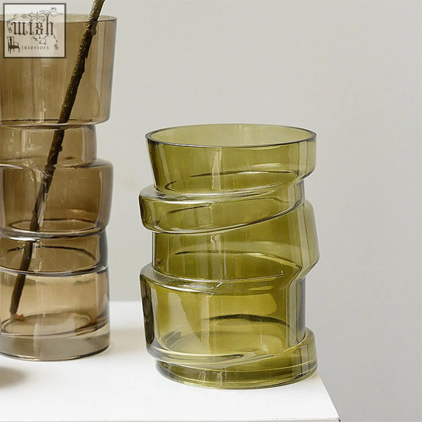 A modern olive green costa glass vase with a stacked spiral design perfect for stylish glass vase decor
