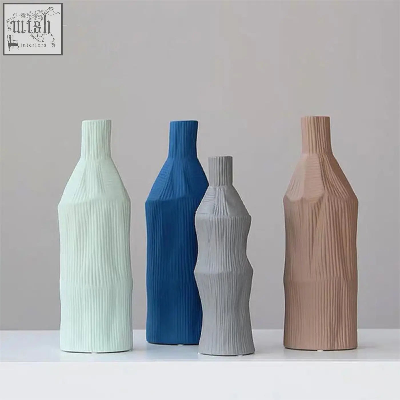 A set of two fresh ceramic vases in pastel mint, bold blue, soft gray, and warm terracotta with ribbed texture easy to clean with damp cloth