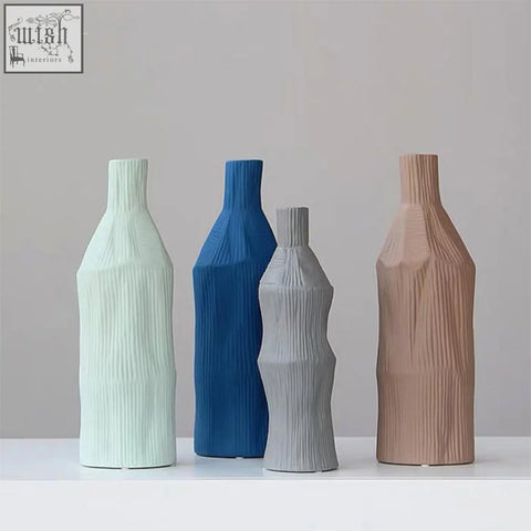 A set of two fresh ceramic vases in pastel mint, bold blue, soft gray, and warm terracotta with ribbed texture easy to clean with damp cloth