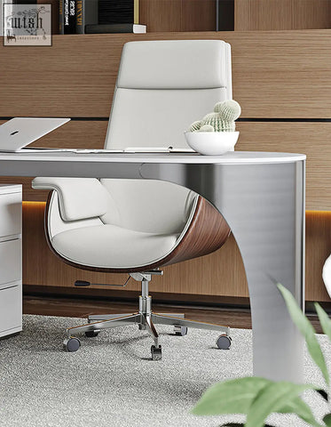 White leather office chair with curved wooden accent and chrome base next to sintered stone corner office desk with storage