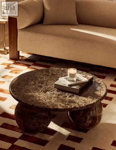 Dark brown marble coffee table with rounded globe-like legs in the abdurrahman round coffee table all marble design