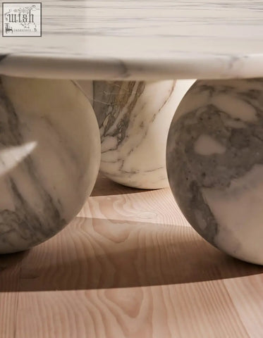 Abdurrahman round coffee table with polished white marble top and three rounded veined marble legs perfect marble coffee table