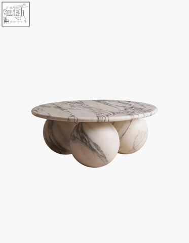 Abdurrahman round coffee table with a sleek white marble top and matching spherical legs is a stylish marble coffee table