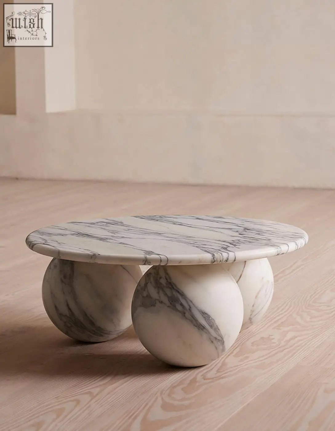 Abdurrahman round coffee table featuring a sleek white and gray veined marble coffee table with spherical bases
