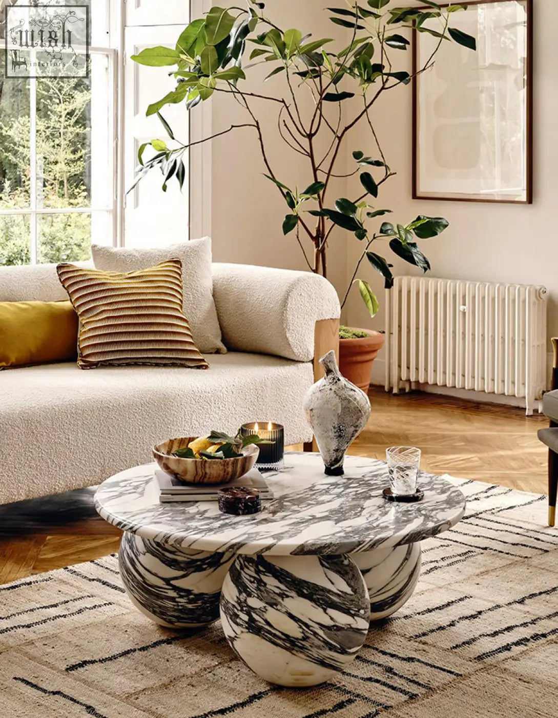 Abdurrahman round coffee table is a marble coffee table with a swirling black and white pattern and sculptural legs
