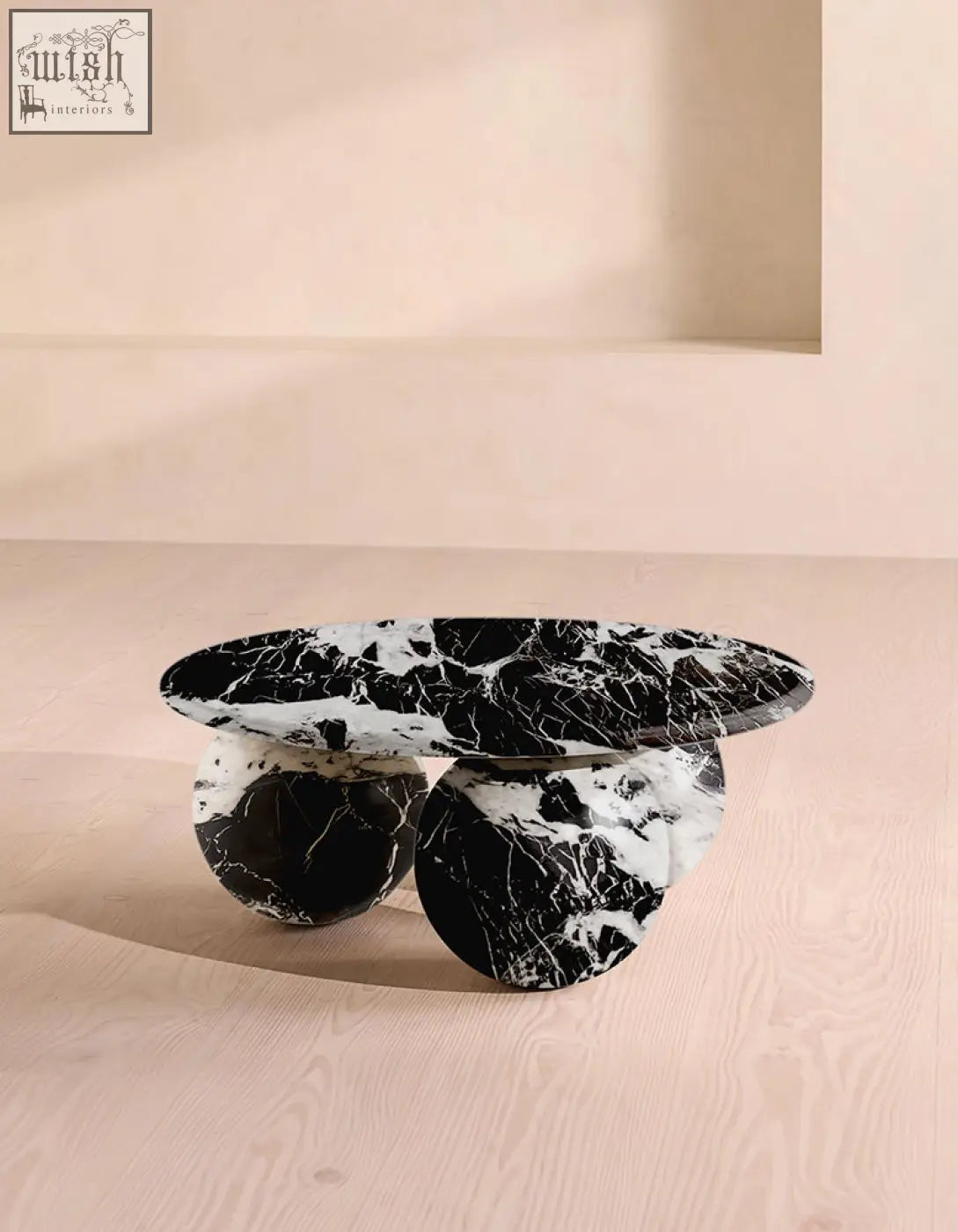 Abdurrahman round coffee table is a black and white marble coffee table with a sleek oval top and polished stone bases