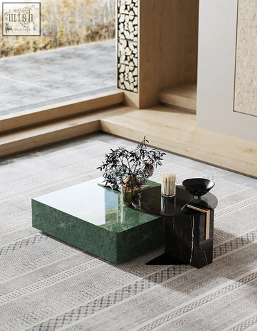 Modern two-toned coffee table set with glossy emerald green marble top and black marble base in sleek geometric design