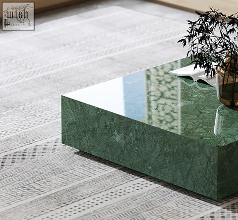 A sleek rectangular coffee table with a glossy green marble top and sharp edges from the aberdeen coffee table set