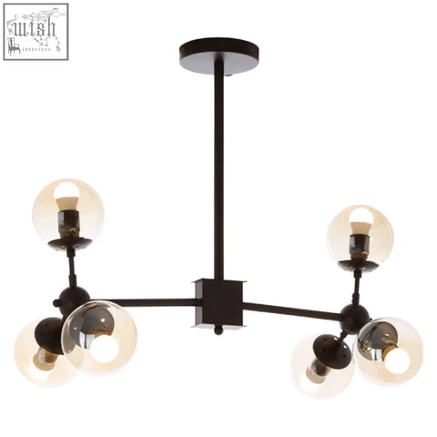 Black metal chandelier with six exposed bulbs and clear glass globe shades in a matte black pendant light design