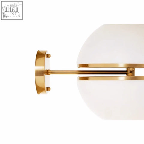 Abira brushed brass wall light with gold-toned sconce and frosted white glass ball shade for stylish lighting