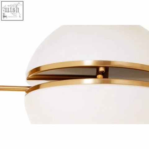 Abira brushed brass ball wall light with sleek white opal glass shade and polished brass accents wall light