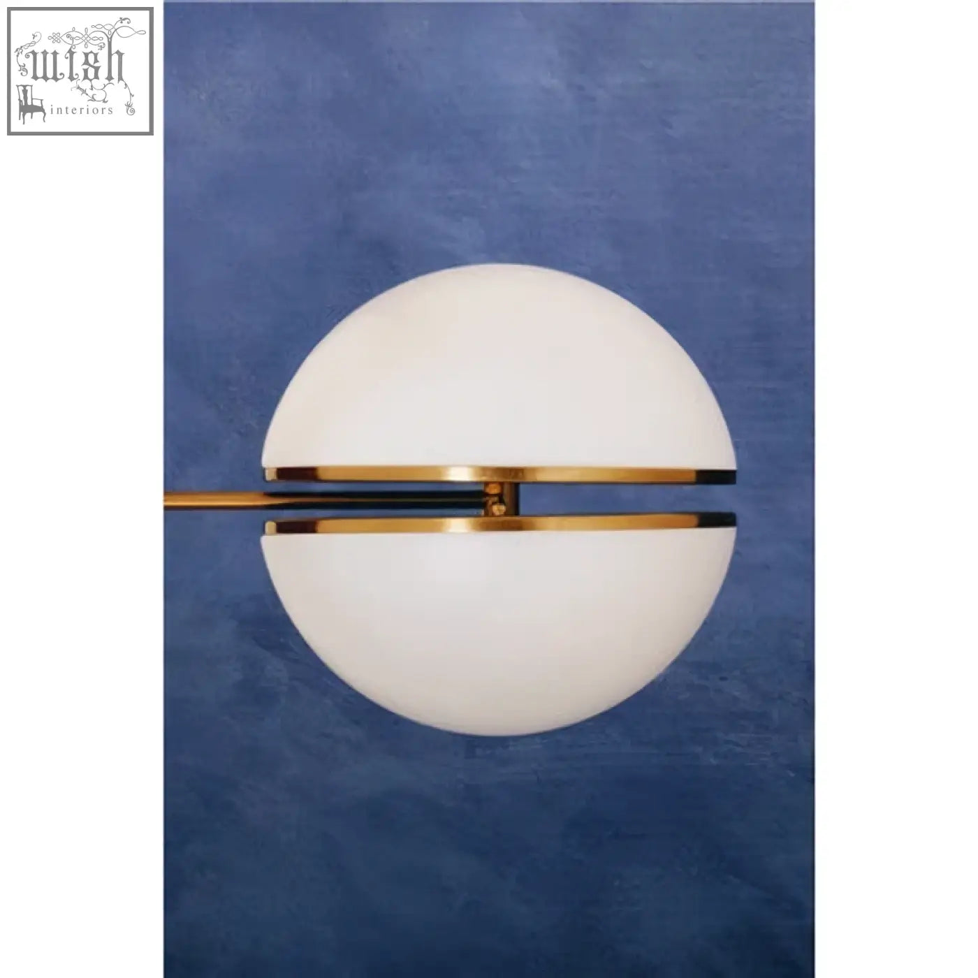 Abira brushed brass ball wall light with sleek white glass sphere and polished gold and black brass wall accent bar