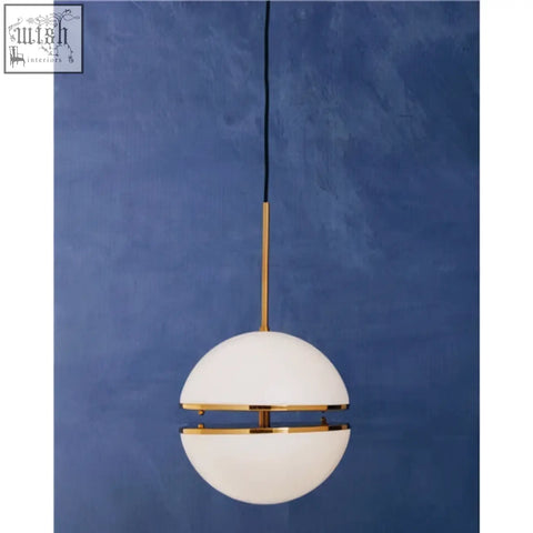 A sleek abira brushed brass pendant light with white opal glass globe and gold-toned metal accents