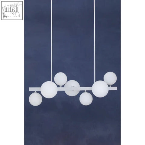 Abira chrome 7 light pendant lamp with white spherical shades on a sleek chrome pendant lamp bar