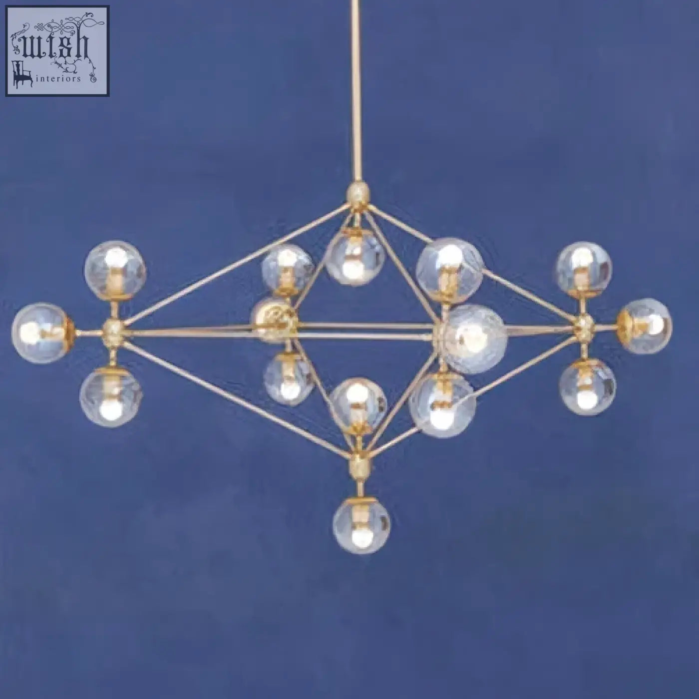 Gold-toned geometric arm pendant light with clear glass globe bulbs in diamond-shaped frame for modern spaces