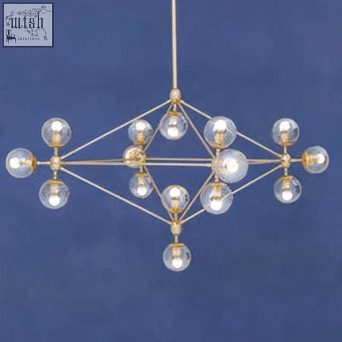 Gold-toned geometric arm pendant light with clear glass globe bulbs in diamond-shaped frame for modern spaces