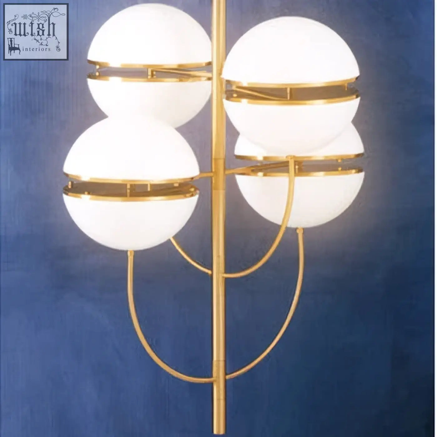 Gold-toned abira four ball brass pendant light with four frosted glass globe shades in a symmetrical design
