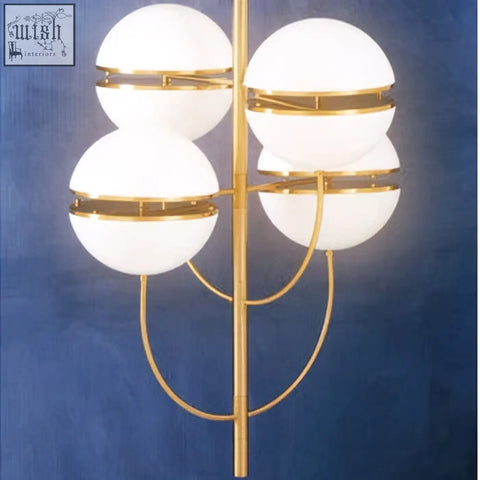 Gold-toned abira four ball brass pendant light with four frosted glass globe shades in a symmetrical design