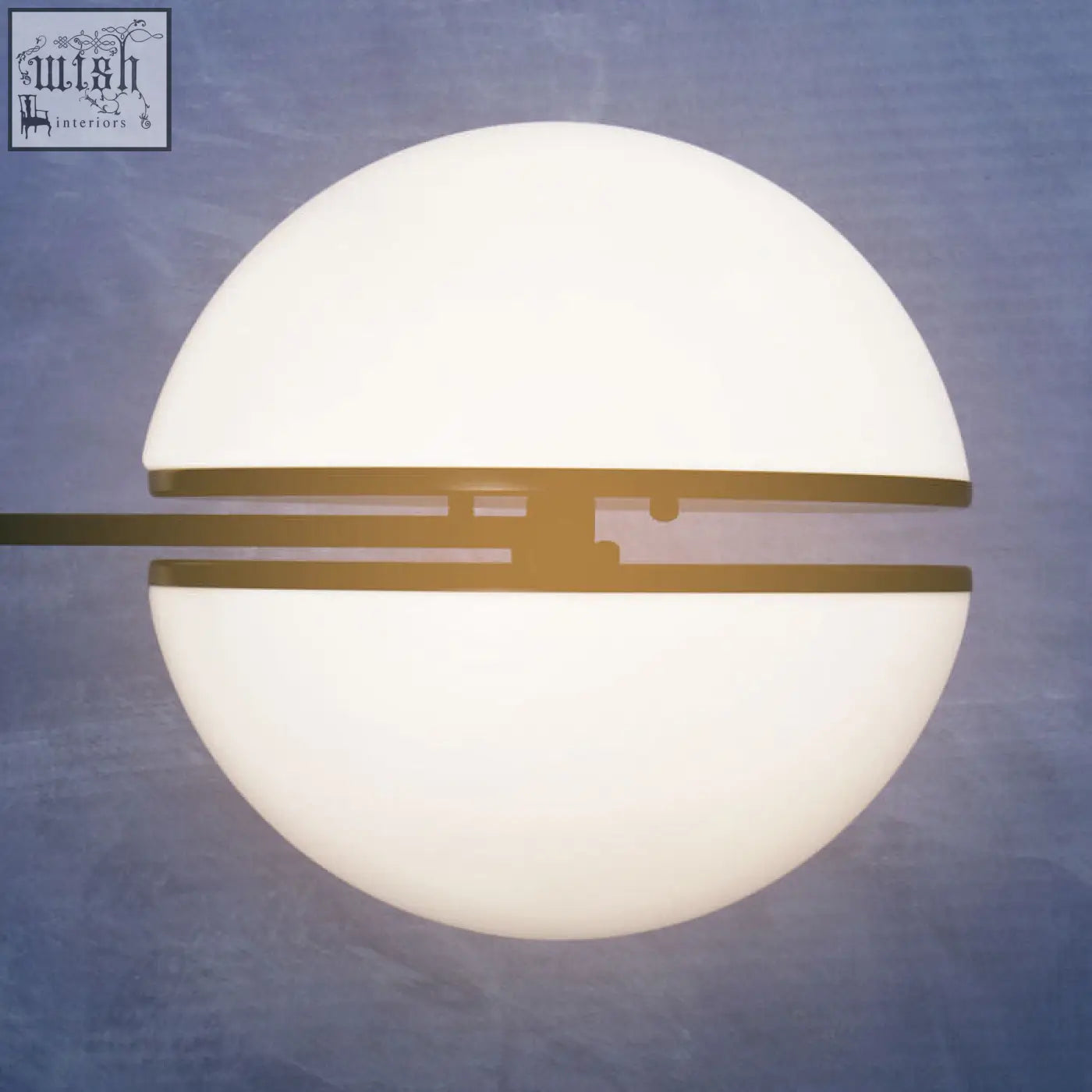 A sleek abira matt black ball wall light with frosted white glass dome and gold-toned metal bands