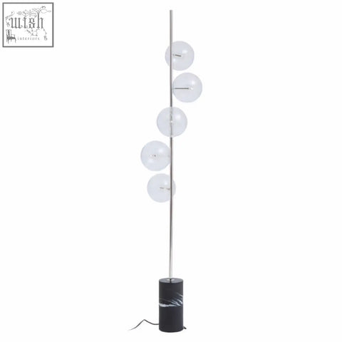 Modern abira nickel floor lamp with slender chrome pole and five glass spheres on a black marble base