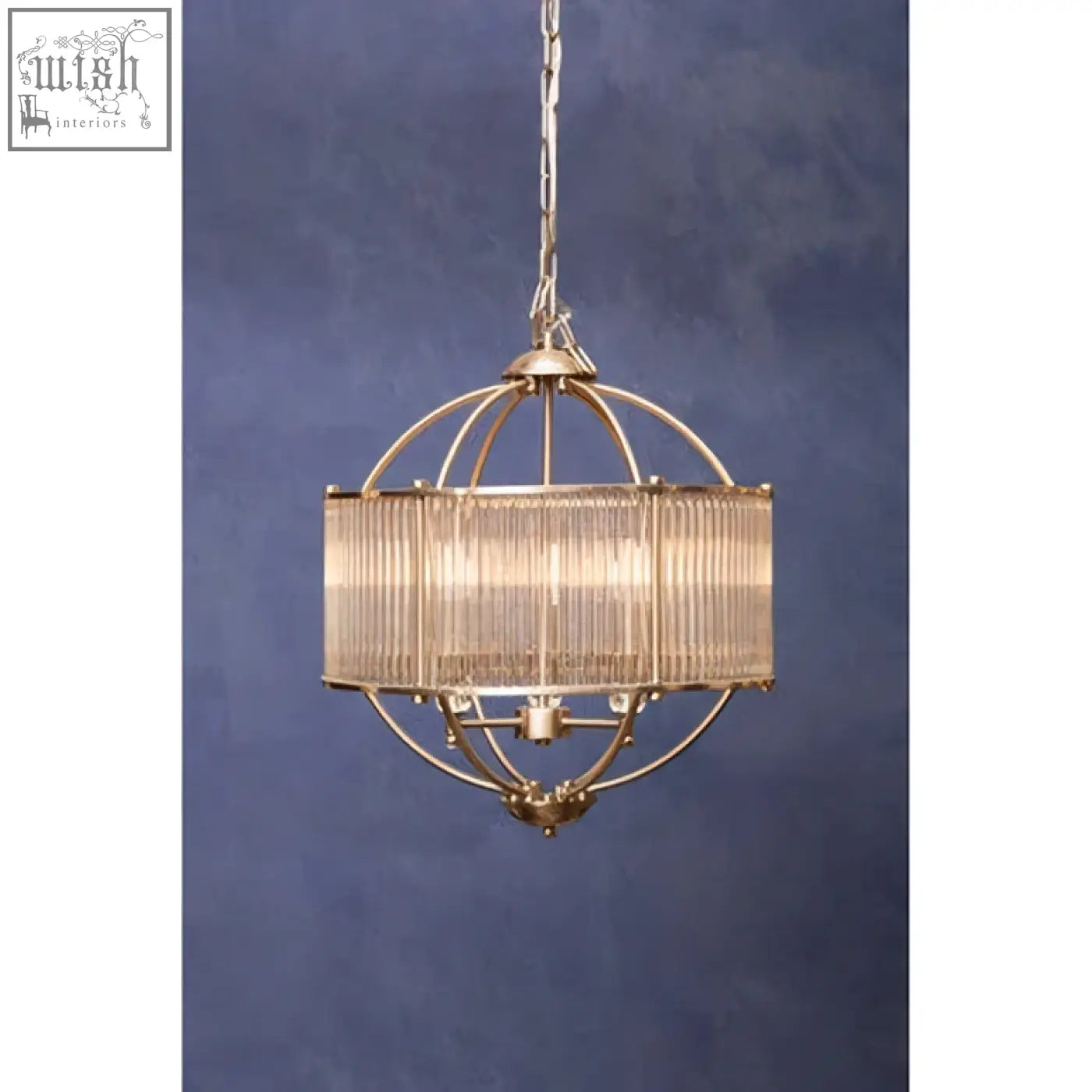 Abira pendant light featuring a brass finish spherical frame with a cylindrical glass shade and ornate chain suspension
