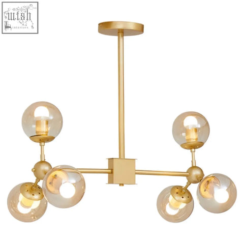 Abira six arm gold finish pendant light with five spherical glass globes in a modern six arm pendant design