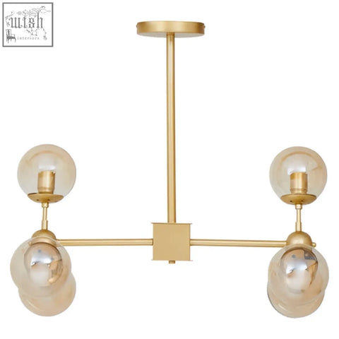 Abira six arm gold finish pendant light with six spherical glass bulbs in a modern gold-toned six arm pendant design