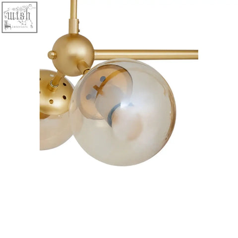 Abira six arm gold finish pendant light with gold-toned spherical glass globes and brass hardware