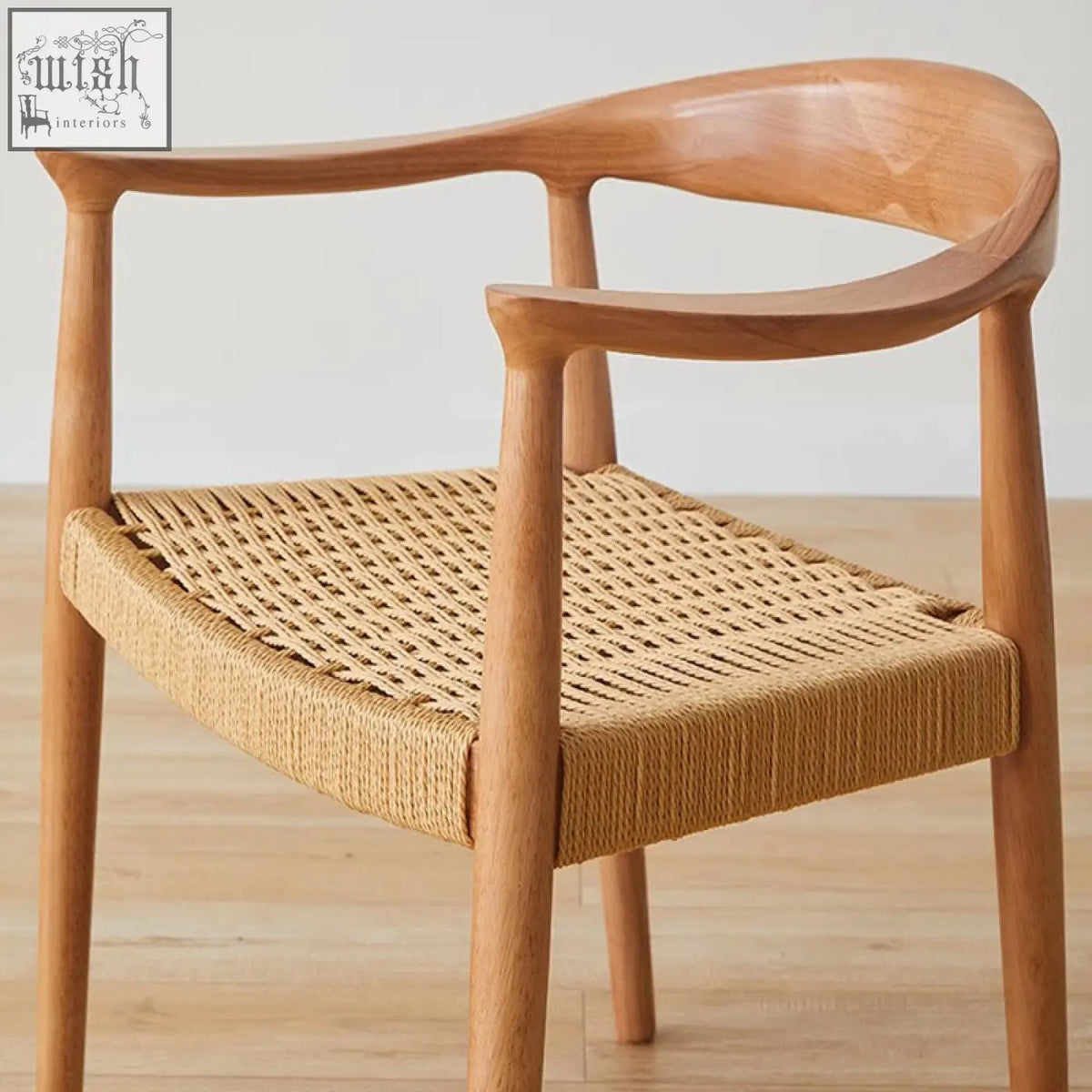 Abiram rattan dining chair with a light wood frame and woven natural fiber seat perfect for solid wood dining