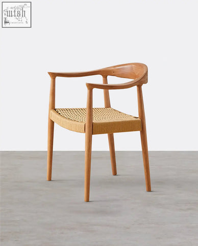 Abiram rattan dining chair with a minimalist light wood frame and woven wicker seat perfect for dining rooms