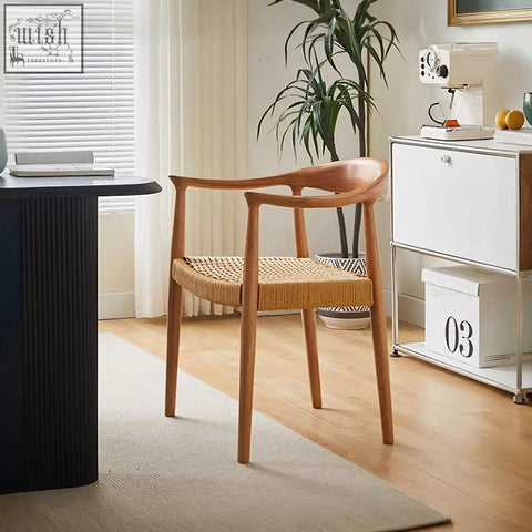 A sleek abiram rattan dining chair with solid wood frame and woven wicker seat in natural wood tones