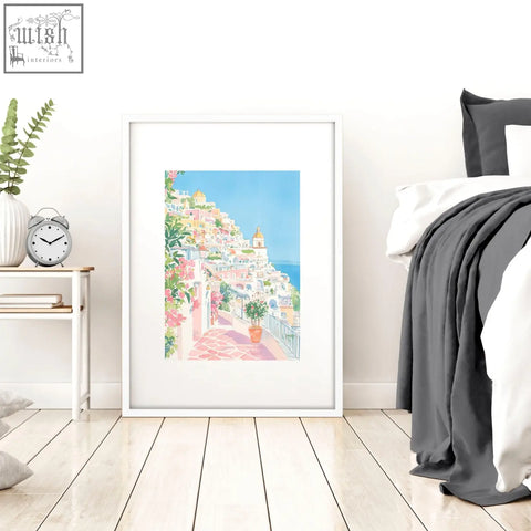 A set of 3 beach decor wall art prints featuring colorful coastal village watercolor in white frames for bed wall decor