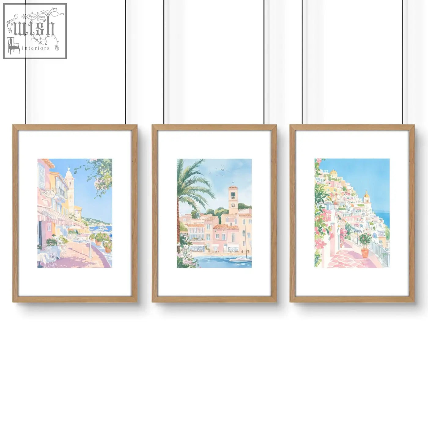 Set of 3 watercolor wall art prints of mediterranean coastal towns in light wood frames perfect for bed wall decor