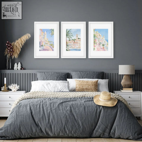 A woven straw hat with a beige band on a gray bedspread complements above the bed wall decor beach wall art set of 3