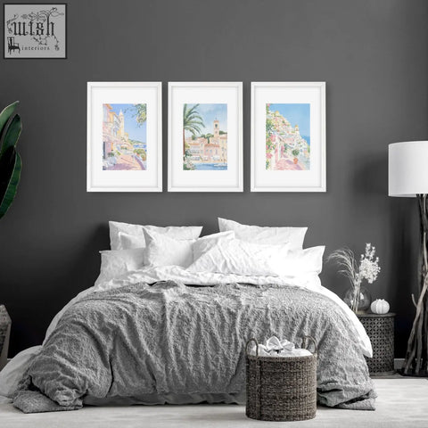 Woven wicker laundry basket with handles shown alongside set of 3 beach decor wall art for above the bed wall decor