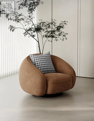 Brown suede abreu swivel accent chair with round armchair design and houndstooth-patterned cushion