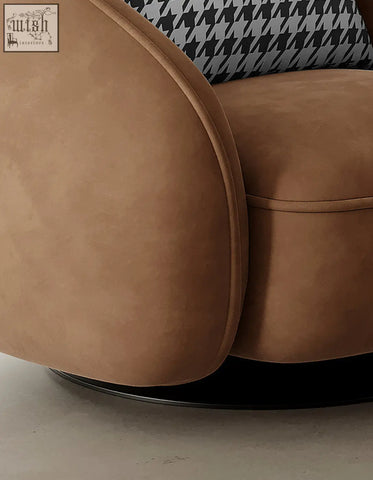 Tan faux leather abreu swivel accent round armchair with sleek curved design and black and white houndstooth cushion