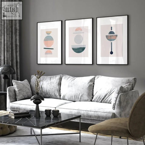 Gray velvet sofa with white cushions in a living room featuring abstract art prints set of 3 framed wall art