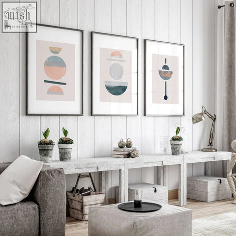 Three framed abstract art prints in black frames with soft pastel geometric designs perfect for living room decor
