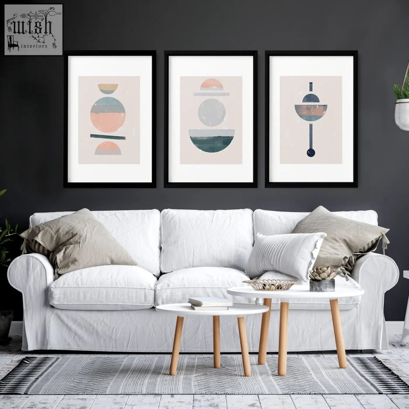 White upholstered sofa with beige and white throw pillows in living room featuring abstract art set of 3 framed art prints