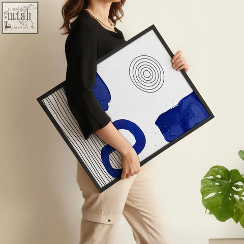 Black-framed abstract art print with bold cobalt blue brushstrokes and geometric lines for modern wall art set of 3