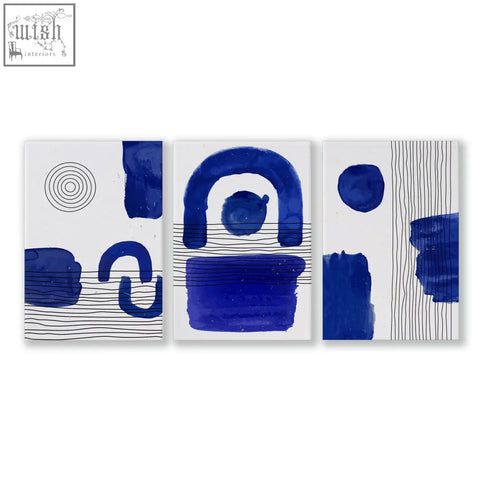 Set of 3 abstract wall art prints with bold blue and white brushstrokes and minimalist geometric patterns on canvas