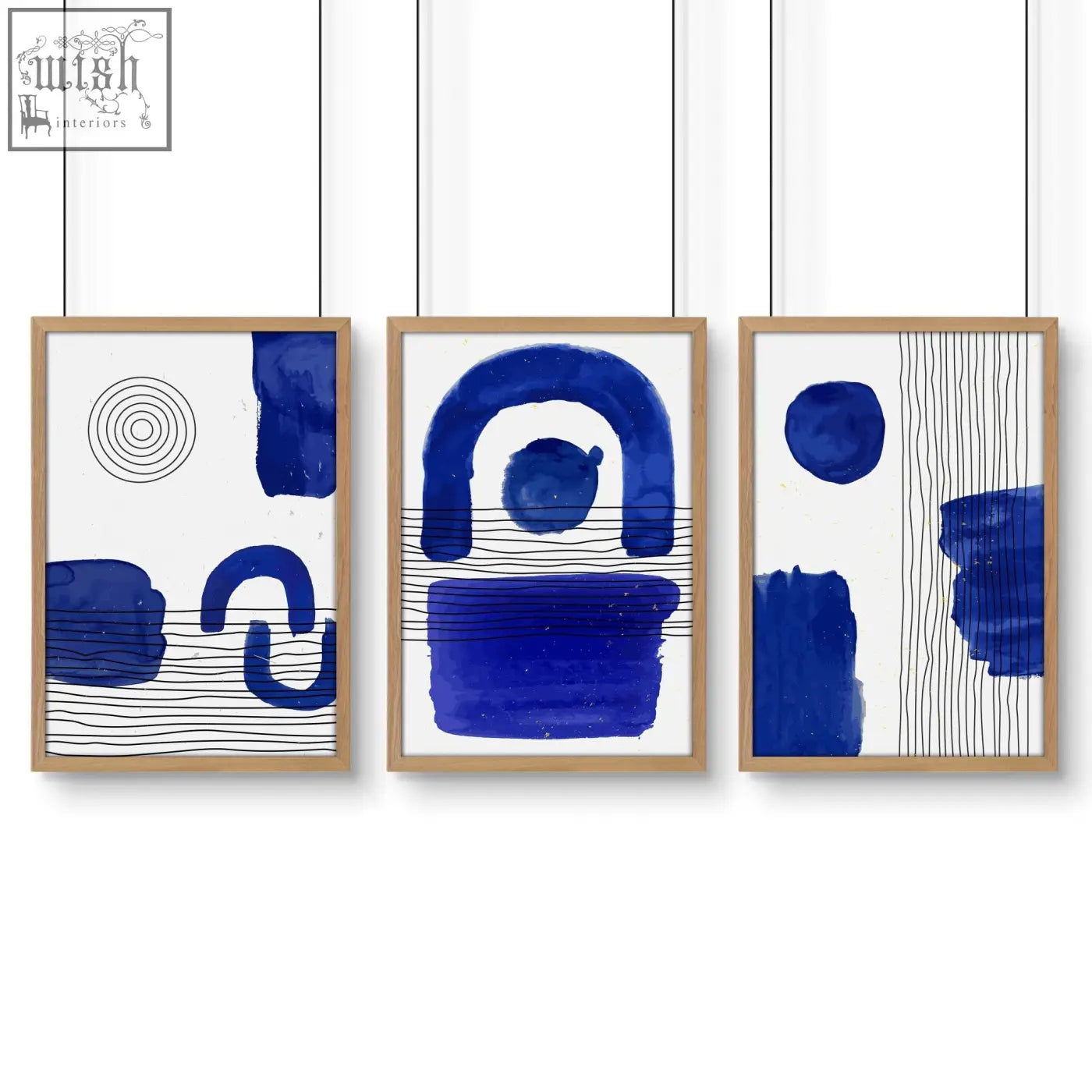 Set of 3 abstract art prints with bold blue brushstrokes and black lines in light wood frames for wall art