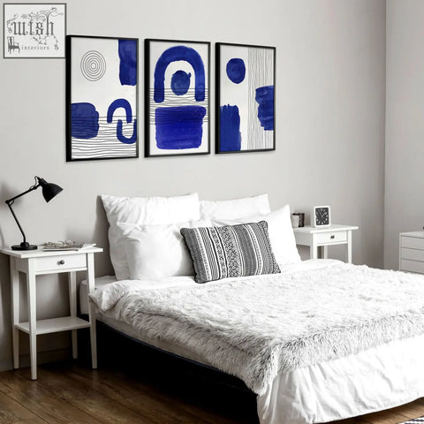 Set of 3 abstract wall art prints featuring bold blue brushstrokes and geometric patterns on white backgrounds