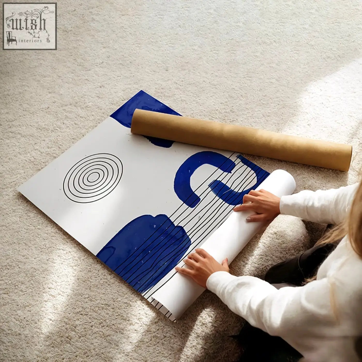 A modern abstract art print with bold blue shapes and black circles on white rolled by hands for wall art decor