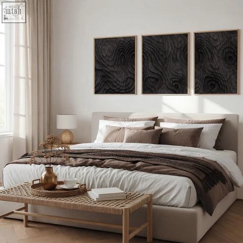 Set of three abstract artwork panels with dark charcoal topographic wave design on black wood with light wooden frames