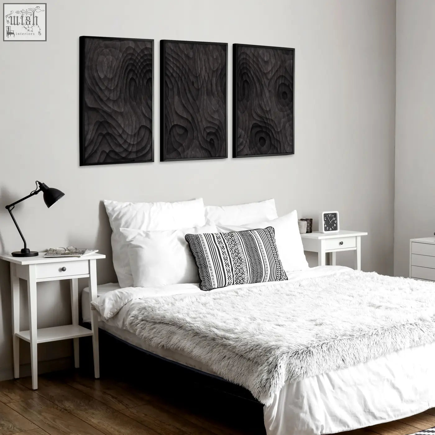 Three black wood grain wall art panels with raised textured patterns in dark charcoal abstract topographic wave design