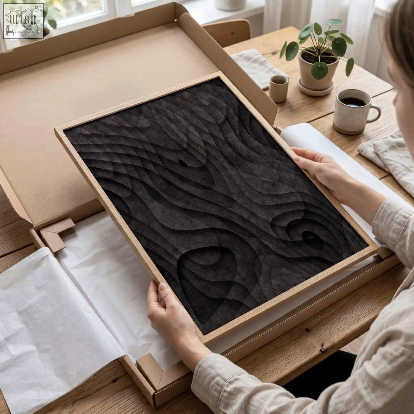 A rectangular black wood relief art piece with dark charcoal topographic wave grooves in a light wooden frame